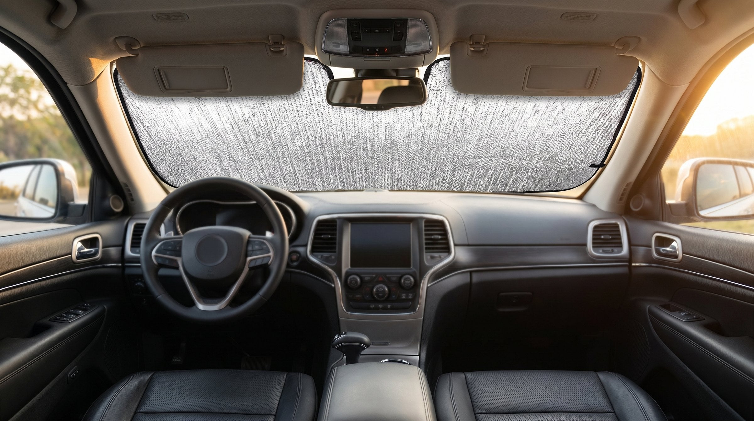 Silver custom-fit sunshade fitted inside an SUV windshield